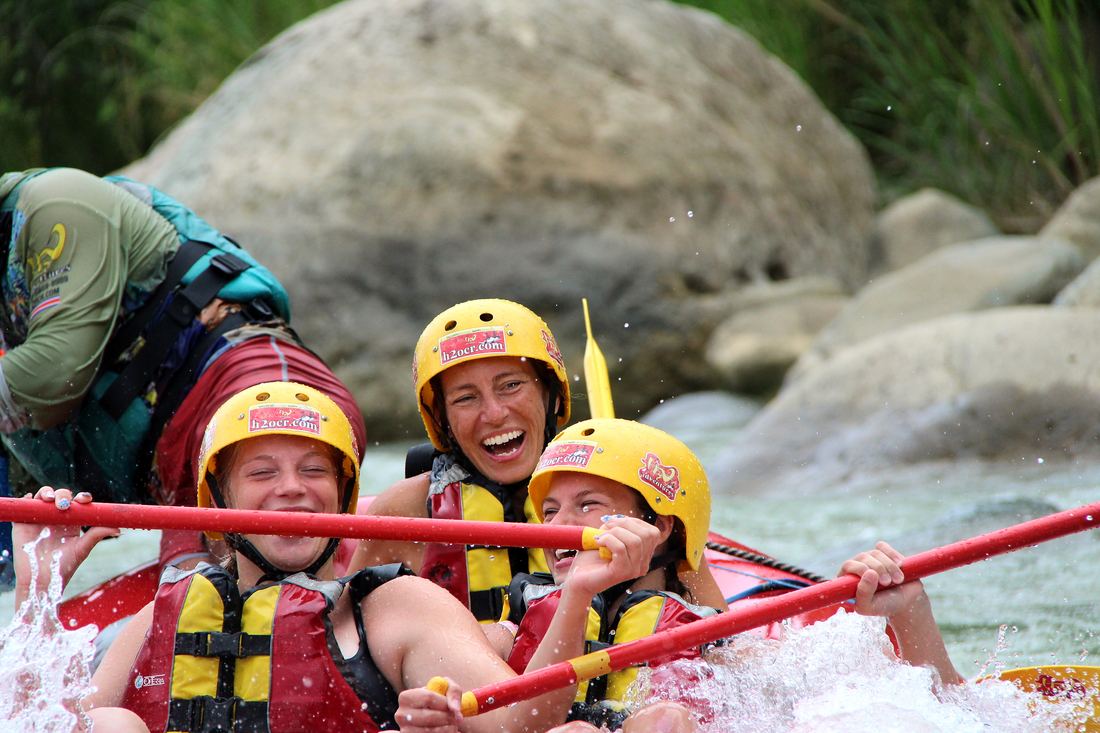 Guests smiling in a raft on the Naranjo