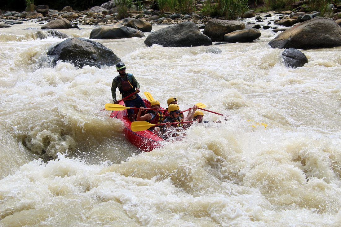 A raft disappearing into a big wave on the Naranjo
