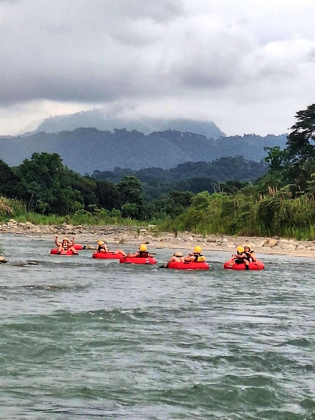A line of tubes floating down the Naranjo under the mountains